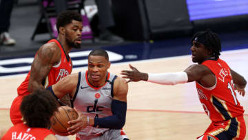Russell Westbrook #4 of the Washington Wizards drives around Naji Marshall #8 and Kira Lewis Jr. #13 of the New Orleans Pelicans (Photo by Rob Carr/Getty Images)