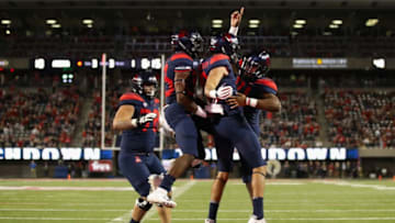 TUCSON, AZ - NOVEMBER 02: Wide receiver Shawn Poindexter #19 and quarterback Khalil Tate #14 of the Arizona Wildcats celebrate after Poindexter caught a one yard touchdown reception against the Colorado Buffaloes during the first half of the college football game at Arizona Stadium on November 2, 2018 in Tucson, Arizona. (Photo by Christian Petersen/Getty Images)