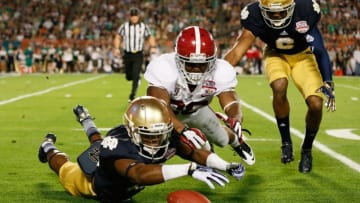MIAMI GARDENS, FL - JANUARY 07: Davonte' Neal #19 of the Notre Dame Fighting Irish fights for a loose ball after muffing the punt against Landon Collins #26 of the Alabama Crimson Tide in the second quarter against the Alabama Crimson Tide during the 2013 Discover BCS National Championship game at Sun Life Stadium on January 7, 2013 in Miami Gardens, Florida. (Photo by Kevin C. Cox/Getty Images)