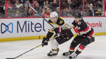 Nov 19, 2016; Ottawa, Ontario, CAN; Boston Bruins defenseman Brandon Carlo (25) and Ottawa Senators center Chris Kelly (22) battle for the puck in the second period at the Canadian Tire Centre. Mandatory Credit: Marc DesRosiers-USA TODAY Sports