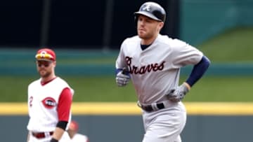 Jul 20, 2016; Cincinnati, OH, USA; Atlanta Braves first baseman Freddie Freeman (R) rounds the bases past Cincinnati Reds shortstop Zack Cozart (2) after Freeman hit a solo home run in the first inning at Great American Ball Park. Mandatory Credit: David Kohl-USA TODAY Sports