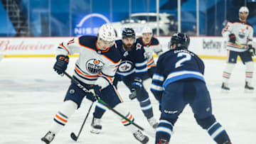 Apr 28, 2021; Winnipeg, Manitoba, CAN; Edmonton Oilers forward Ryan McLeod (71) skates in on Winnipeg Jets defenseman Dylan Demelo (2) during the first period at Bell MTS Place. Mandatory Credit: Terrence Lee-USA TODAY Sports