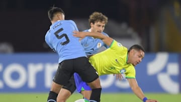 Brazil's Vitor Roque (R) is marked by Uruguay's Fabricio Diaz (5) and Juan Boselli during their South American U-20 football championship final round match at El Campin stadium in Bogota, on February 12, 2023. (Photo by DANIEL MUNOZ / AFP) (Photo by DANIEL MUNOZ/AFP via Getty Images)