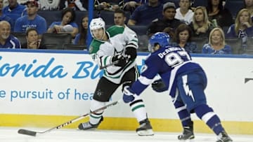 Sep 26, 2014; Tampa, FL, USA; Dallas Stars center Jason Spezza (90) passes the puck as Tampa Bay Lightning defenseman Anthony DeAngelo (97) defends during the third period at Amalie Arena. Tampa Bay Lightning defeated the Dallas Stars 6-3. Mandatory Credit: Kim Klement-USA TODAY Sports