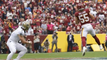 Oct 10, 2021; Landover, Maryland, USA; Washington Football Team linebacker Cole Holcomb (55) intercepts a pass intended for New Orleans Saints wide receiver Taysom Hill (7) during the first quarter at FedExField. Mandatory Credit: Geoff Burke-USA TODAY Sports