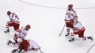Apr 11, 2015; Boston, MA, USA; Boston University Terriers forward Nick Roberto (15) consoles forward Evan Rodrigues (17) after being defeated by the Providence College Friars 4-3 in the championship game of the Frozen Four college ice hockey tournament at TD Garden. Mandatory Credit: Greg M. Cooper-USA TODAY Sports