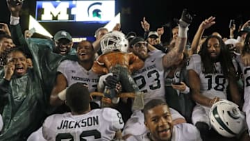ANN ARBOR, MI - OCTOBER 07: Chris Frey #23 of Michigan State Spartans celebrate with his teammates a win over Michigan Wolverines with the Paul Banyun trophy at Michigan Stadium on October 7, 2017 in Ann Arbor, Michigan. Michigan State defeated Michigan 14-10. (Photo by Leon Halip/Getty Images)
