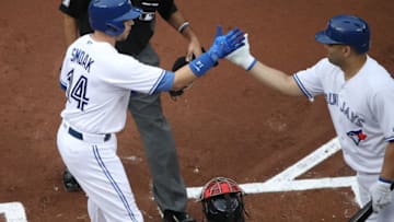 TORONTO, ON - JUNE 30: Justin Smoak #14 of the Toronto Blue Jays is congratulated by Kendrys Morales #8 after hitting a three-run home run in the first inning during MLB game action against the Boston Red Sox at Rogers Centre on June 30, 2017 in Toronto, Canada. (Photo by Tom Szczerbowski/Getty Images)