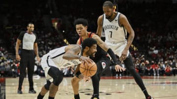 Jan 10, 2022; Portland, Oregon, USA; Brooklyn Nets forward Kevin Durant (7) sets a pick during the first half against Portland Trail Blazers guard Anfernee Simons (1) as guard Kyrie Irving (11) drives to the basket at Moda Center. Mandatory Credit: Troy Wayrynen-USA TODAY Sports