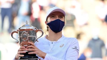 Poland's Iga Swiatek celebrates with the Suzanne Lenglen trophy during the podium ceremony after winning the women's singles final tennis match against Sofia Kenin of the US, at the Philippe Chatrier court, on Day 14 of The Roland Garros 2020 French Open tennis tournament in Paris on October 10, 2020. (Photo by MARTIN BUREAU / AFP) (Photo by MARTIN BUREAU/AFP via Getty Images)