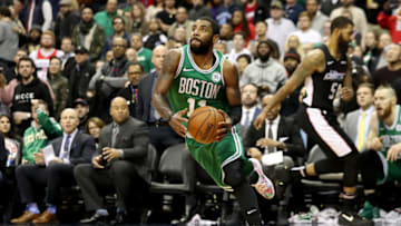 WASHINGTON, DC - DECEMBER 12: Kyrie Irving #11 of the Boston Celtics drives around Markieff Morris #5 of the Washington Wizards in overtime of the Celtics win at Capital One Arena on December 12, 2018 in Washington, DC. NOTE TO USER: User expressly acknowledges and agrees that, by downloading and or using this photograph, User is consenting to the terms and conditions of the Getty Images License Agreement. (Photo by Rob Carr/Getty Images)
