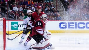 Mar 24, 2016; Glendale, AZ, USA; Arizona Coyotes goalie Louis Domingue (35) watches the puck as Dallas Stars left wing Jamie Benn (14) and defenseman Michael Stone (26) look on during the third period at Gila River Arena. Mandatory Credit: Matt Kartozian-USA TODAY Sports