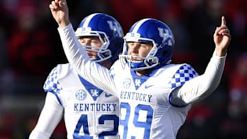 Nov 26, 2016; Louisville, KY, USA; Kentucky Wildcats kicker Austin McGinnis (99) reacts along side wide receiver Kynan Smith (42) after scoring the game winning field goal against the Louisville Cardinals during the second quarter at Papa John