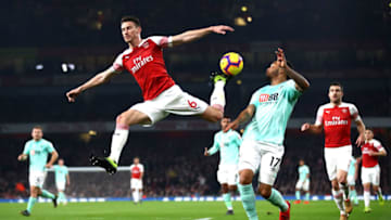 LONDON, ENGLAND - FEBRUARY 27: Laurent Koscielny of Arsenal jumps for the ball under pressure from Joshua King of AFC Bournemouth during the Premier League match between Arsenal FC and AFC Bournemouth at Emirates Stadium on February 27, 2019 in London, United Kingdom. (Photo by Julian Finney/Getty Images)