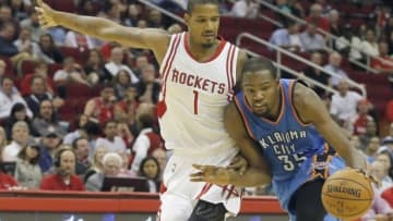 Nov 2, 2015; Houston, TX, USA; Oklahoma City Thunder forward Kevin Durant (35) dribbles against Houston Rockets forward Trevor Ariza (1) in the third quarter at Toyota Center. Rocket won 110 to 105. Mandatory Credit: Thomas B. Shea-USA TODAY Sports