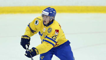 LAKE PLACID, NY - AUGUST 03: Lawrence Pilut #25 of Team Sweden skates against USA White during the 2014 USA Hockey Junior Evaluation Camp at the Lake Placid Olympic Center on August 3, 2014 in Lake Placid, New York. (Photo by Bruce Bennett/Getty Images)