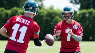 Jun 9, 2016; Philadelphia, PA, USA; Philadelphia Eagles quarterback Sam Bradford (7) tosses the ball to quarterback Carson Wentz (11) during mini camp at NovaCare Complex. Mandatory Credit: Bill Streicher-USA TODAY Sports