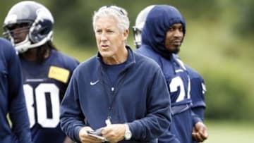 Jun 17, 2014; Renton, WA, USA; Seattle Seahawks head coach Pete Carroll waits for a scrimmage play to start as running back Marshawn Lynch (24, right) walks behind Carroll during minicamp at the Virginia Mason Athletic Center. Mandatory Credit: Joe Nicholson-USA TODAY Sports