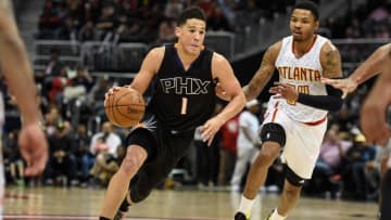 Apr 5, 2016; Atlanta, GA, USA; Phoenix Suns guard Devin Booker (1) dribbles past Atlanta Hawks forward Kent Bazemore (24) during the second half at Philips Arena. The Hawks defeated the Suns 103-90. Mandatory Credit: Dale Zanine-USA TODAY Sports