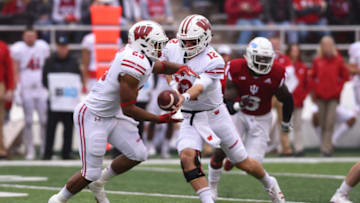 BLOOMINGTON, IN - NOVEMBER 04: Wisconsin (12) Alex Hornibrook (QB) handing the ball of to (23) Jonathan Taylor (RB) during a college football game between the Wisconsin Badgers and the Indiana Hoosiers on November 4, 2017 at Memorial Stadium in Bloomington, IN. (Photo by James Black/Icon Sportswire via Getty Images)