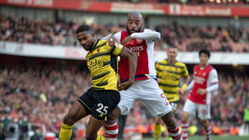 LONDON, ENGLAND - NOVEMBER 07: Emmanuel Dennis of Watford and Alexandre Lacazette of Arsenal in action during the Premier League match between Arsenal and Watford at Emirates Stadium on November 7, 2021 in London, England. (Photo by Visionhaus/Getty Images)