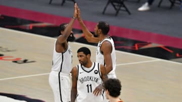 CLEVELAND, OHIO - JANUARY 20: James Harden #13 Kevin Durant #7 and Kyrie Irving #11 of the Brooklyn Nets celebrate (Photo by Jason Miller/Getty Images)
