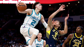 CHARLOTTE, NORTH CAROLINA - OCTOBER 20: LaMelo Ball #2 of the Charlotte Hornets drives to the basket against Chris Duarte #3 of the Indiana Pacers during the second half of their game at Spectrum Center on October 20, 2021 in Charlotte, North Carolina. The Hornets won 123-122. NOTE TO USER: User expressly acknowledges and agrees that, by downloading and/or using this Photograph, user is consenting to the terms and conditions of the Getty Images License Agreement. (Photo by Grant Halverson/Getty Images)