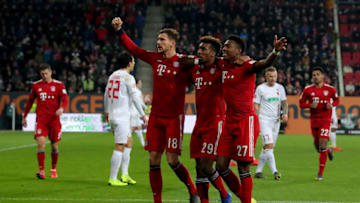 AUGSBURG, GERMANY - FEBRUARY 15: David Alaba #27 of Muenchen celebrate with team mate Kingsley Coman #29 and Leon Goretzka #18 after he scores the 3rd goal during the Bundesliga match between FC Augsburg and FC Bayern Muenchen at WWK-Arena on February 15, 2019 in Augsburg, Germany. (Photo by Alexander Hassenstein/Bongarts/Getty Images)