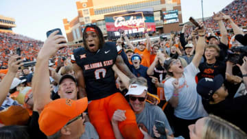 Oklahoma State Cowboys running back Ollie Gordon II (0) celebrates with fans after a Bedlam college football game between the Oklahoma State University Cowboys (OSU) and the University of Oklahoma Sooners (OU) at Boone Pickens Stadium in Stillwater, Okla., Saturday, Nov. 4, 2023. Oklahoma State won 27-24.