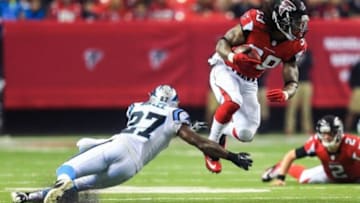 Dec 29, 2013; Atlanta, GA, USA; Atlanta Falcons running back Steven Jackson (39) is tackled by Carolina Panthers safety Quintin Mikell (27) in the first half at the Georgia Dome. Mandatory Credit: Daniel Shirey-USA TODAY Sports