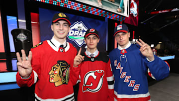 VANCOUVER, BRITISH COLUMBIA - JUNE 21: (L-R) Kirby Dach, third overall pick by the Chicago Blackhawks, Jack Hughes, first overall pick by the New Jersey Devils, and Kaapo Kakko, second overall pick by the New York Rangers, hold up their fingers of their pick order in front of the stage during the first round of the 2019 NHL Draft at Rogers Arena on June 21, 2019 in Vancouver, Canada. (Photo by Dave Sandford/NHLI via Getty Images)