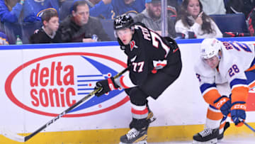 Oct 21, 2023; Buffalo, New York, USA; Buffalo Sabres right wing JJ Peterka (77) skates past New York Islanders defenseman Alexander Romanov (28) with the puck in the second period at KeyBank Center. Mandatory Credit: Mark Konezny-USA TODAY Sports