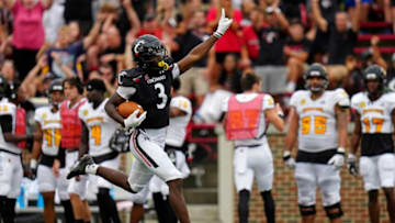 Cincinnati Bearcats safety Ja'von Hicks runs back a pick-six against Kennesaw State. The Enquirer.