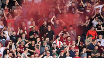 CARDIFF, WALES - APRIL 21: Liverpool fans celebrate their second goal by letting off a flare during the Premier League match between Cardiff City and Liverpool FC at Cardiff City Stadium on April 21, 2019 in Cardiff, United Kingdom. (Photo by Stu Forster/Getty Images)