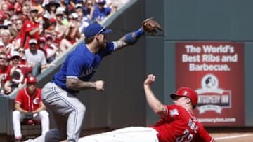 Jun 21, 2014; Cincinnati, OH, USA; Cincinnati Reds right fielder Jay Bruce (32) slides safely into third under Toronto Blue Jays third baseman Brett Lawrie, left, after a hit by Ryan Ludwick in the first inning at Great American Ball Park. Mandatory Credit: David Kohl-USA TODAY Sports