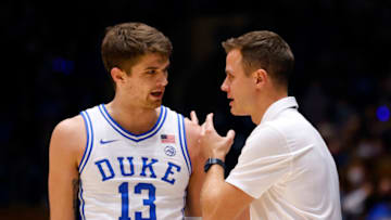 Duke basketball guard Joey Baker and head coach Jon Scheyer (Photo by Grant Halverson/Getty Images)