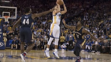 November 7, 2016; Oakland, CA, USA; Golden State Warriors guard Stephen Curry (30) shoots the basketball for his 13th three-point basket against New Orleans Pelicans forward Solomon Hill (44) and guard E'Twaun Moore (55) during the fourth quarter at Oracle Arena. Curry made 13-three point baskets for the NBA record of most three-pointers in a single game. The Warriors defeated the Pelicans 116-106. Mandatory Credit: Kyle Terada-USA TODAY Sports