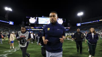 JACKSONVILLE, FLORIDA - DECEMBER 30: Head coach Marcus Freeman of the Notre Dame Fighting Irish exits the field after defeating the South Carolina Gamecocks 45-38 in the TaxSlayer Gator Bowl at TIAA Bank Field on December 30, 2022 in Jacksonville, Florida. (Photo by James Gilbert/Getty Images)