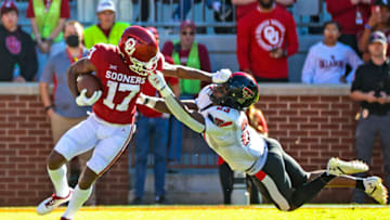 Oct 30, 2021; Norman, Oklahoma, USA; Oklahoma Sooners wide receiver Marvin Mims (17) runs with the ball as Texas Tech Red Raiders defensive back DaMarcus Fields (23) defends during the first quarter at Gaylord Family-Oklahoma Memorial Stadium. Mandatory Credit: Kevin Jairaj-USA TODAY Sports