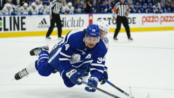 May 4, 2022; Toronto, Ontario, CAN; Toronto Maple Leafs forward Auston Matthews (34) battles with Tampa Bay Lightning forward Ondrej Palat (18) for the puck during the first period of game two of the first round of the 2022 Stanley Cup Playoffs at Scotiabank Arena. Mandatory Credit: John E. Sokolowski-USA TODAY Sports