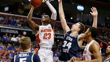 SUNRISE, FLORIDA - DECEMBER 21: Scottie Lewis #23 of the Florida Gators shoots against Justin Bean #34 of the Utah State Aggies during the second half of the Orange Bowl Basketball Classic at BB&T Center on December 21, 2019 in Sunrise, Florida. (Photo by Michael Reaves/Getty Images)