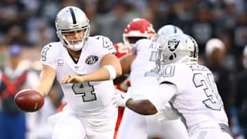 OAKLAND, CA - OCTOBER 19: Derek Carr #4 of the Oakland Raiders hands off the ball to Jalen Richard #30 of the Oakland Raiders during their NFL game at Oakland-Alameda County Coliseum on October 19, 2017 in Oakland, California. (Photo by Ezra Shaw/Getty Images)