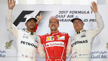 BAHRAIN, BAHRAIN - APRIL 16: Top three finishers Sebastian Vettel of Germany and Ferrari, Lewis Hamilton of Great Britain and Mercedes GP and Valtteri Bottas of Finland and Mercedes GP on the podium during the Bahrain Formula One Grand Prix at Bahrain International Circuit on April 16, 2017 in Bahrain, Bahrain. (Photo by Clive Mason/Getty Images)