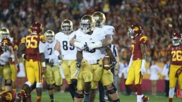 LOS ANGELES, CA - NOVEMBER 24: Running back Theo Riddick #6 of the Notre Dame Fighting Irish celebrates a touchdown with teammate Braxston Cave #52 in the first half against the USC Trojans at Los Angeles Memorial Coliseum on November 24, 2012 in Los Angeles, California. (Photo by Jeff Gross/Getty Images)