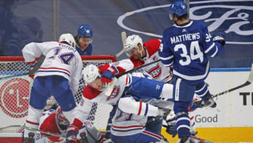 Auston Matthews #34 of the Toronto Maple Leafs checks Ben Chiarot #8 of the Montreal Canadiens. (Photo by Claus Andersen/Getty Images)