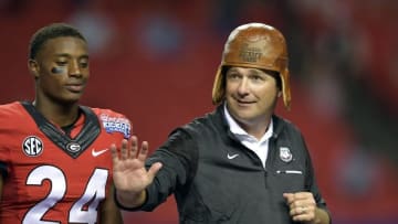 Sep 3, 2016; Atlanta, GA, USA; Georgia Bulldogs head coach Kirby Smart puts on the Old Leather Helmet after the 2016 Chick-Fil-A Kickoff game against the North Carolina Tar Heels at Georgia Dome. Georgia won 33-24. Mandatory Credit: Dale Zanine-USA TODAY Sports