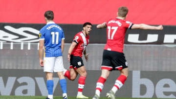 SOUTHAMPTON, ENGLAND - MARCH 14: Che Adams of Southampton is congratulated by team-mate Stuart Armstrong after he scores a goal to make it 1-1 during the Premier League match between Southampton and Brighton & Hove Albion at St Mary's Stadium on March 14, 2021 in Southampton, England. Sporting stadiums around the UK remain under strict restrictions due to the Coronavirus Pandemic as Government social distancing laws prohibit fans inside venues resulting in games being played behind closed doors. (Photo by Robin Jones/Getty Images)