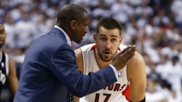 Apr 30, 2014; Toronto, Ontario, CAN; Toronto Raptors head coach Dwane Casey talks to Toronto Raptors center Jonas Valanciunas (17) during a break in the action against the Brooklyn Nets in game five of the first round of the 2014 NBA Playoffs at the Air Canada Centre. Toronto defeated Brooklyn 115-113. Mandatory Credit: John E. Sokolowski-USA TODAY Sports