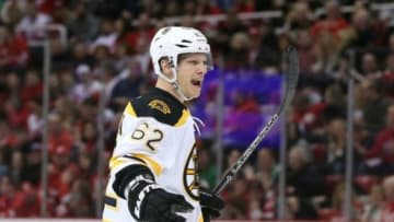 Feb 14, 2016; Detroit, MI, USA; Boston Bruins defenseman Zach Trotman (62) celebrates after scoring a first period goal during the game against the Detroit Red Wings at Joe Louis Arena. Mandatory Credit: Leon Halip-USA TODAY Sports