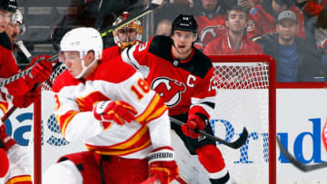 NEWARK, NEW JERSEY - OCTOBER 26: Nico Hischier #13 of the New Jersey Devils screens Dan Vladar #80 of the Calgary Flames during the first period at the Prudential Center on October 26, 2021 in Newark, New Jersey. (Photo by Bruce Bennett/Getty Images)